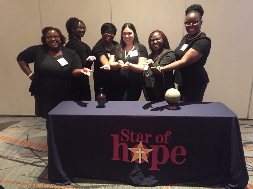 The team from Star of Hope Mission’s youth and family shelter displays the Play-Doh they brought to help people understand the process of molding those they help (and being molded themselves in the process).
